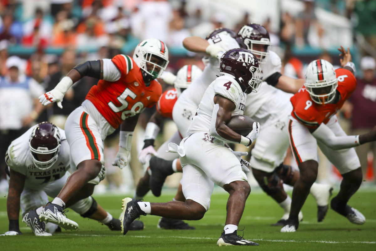 Sep 9, 2023; Miami Gardens, Florida, USA; Texas A&M Aggies running back Amari Daniels (4) runs with the football against the Miami Hurricanes during the first quarter at Hard Rock Stadium. Mandatory Credit: Sam Navarro-USA TODAY Sports